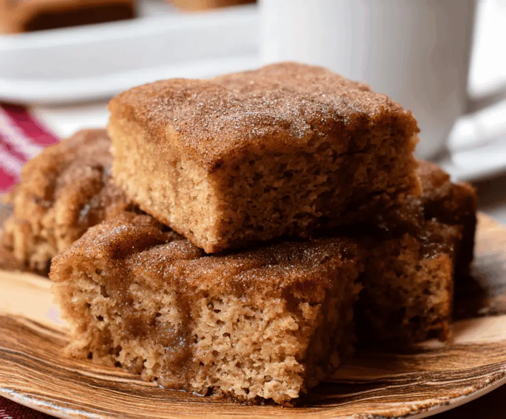 Delicious Apple Cider Donut Snack Cake topped with cinnamon glaze and apple slices, perfect for fall desserts.