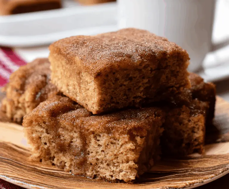 Delicious Apple Cider Donut Snack Cake topped with cinnamon glaze and apple slices, perfect for fall desserts.