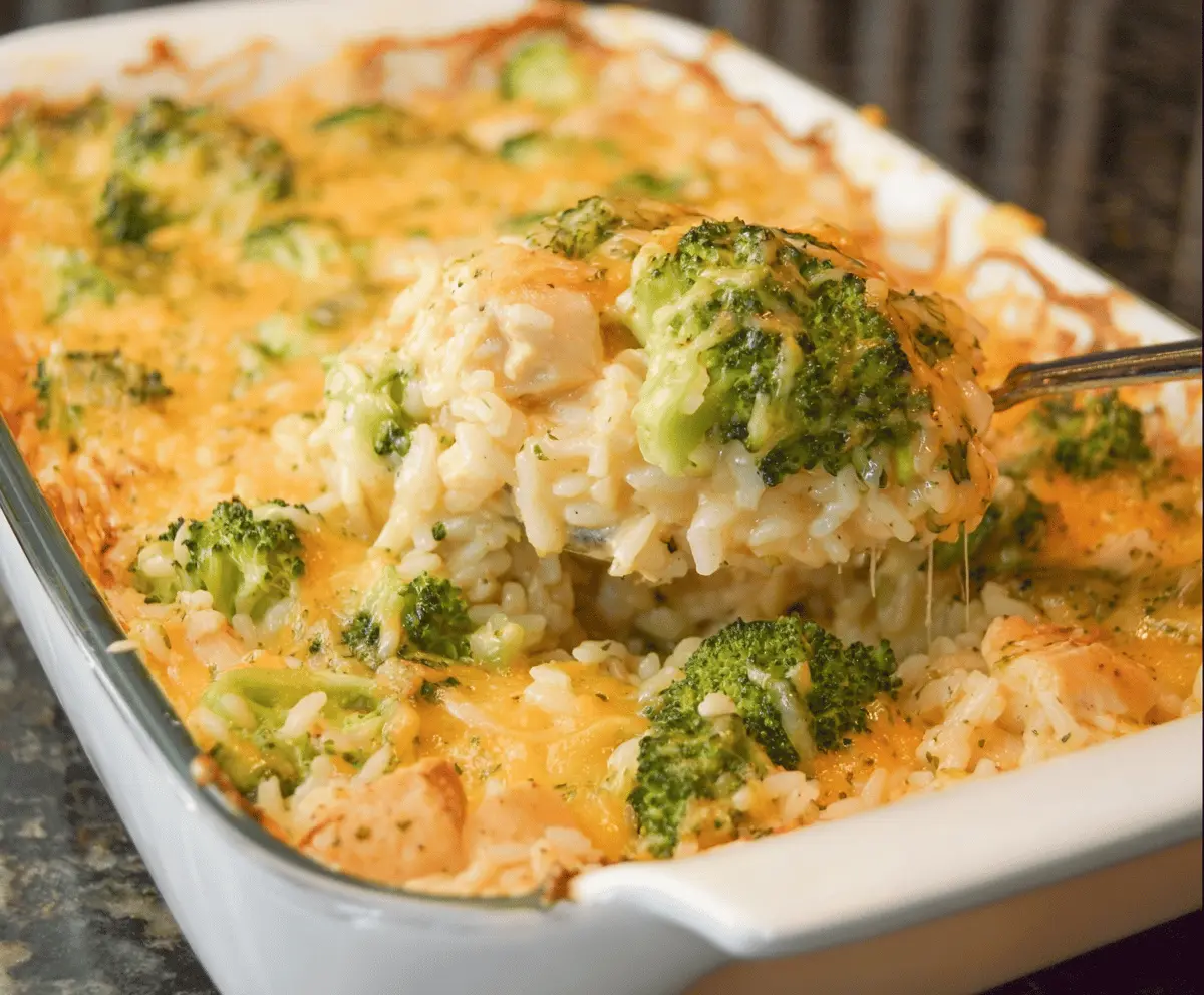 Creamy Chicken Broccoli Rice Cheese Casserole by MunchFoodie Baked Creamy Chicken Broccoli Rice Cheese Casserole in a dish