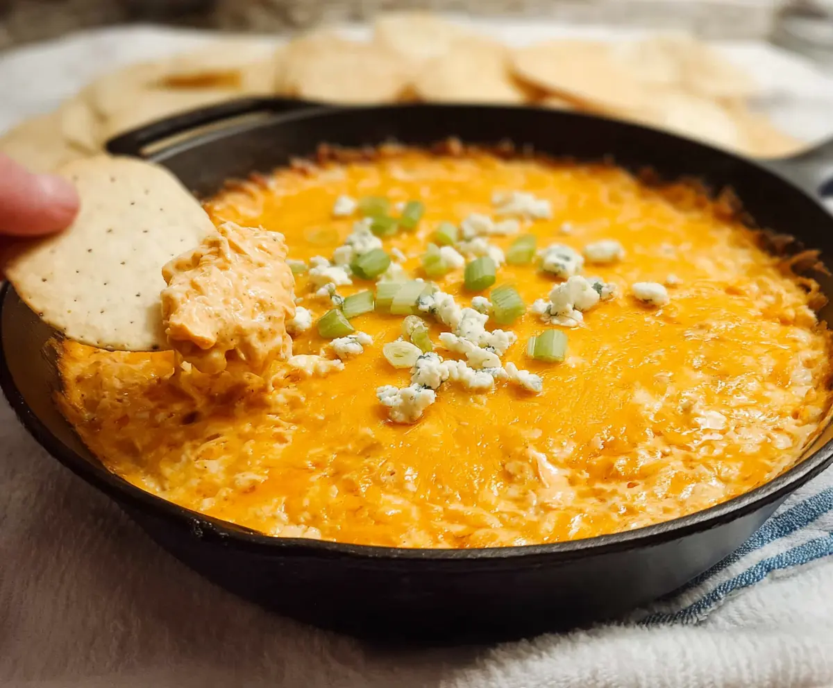 Delicious creamy Buffalo Chicken Dip served with fresh vegetables and chips for a perfect appetizer.