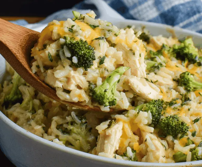 Delicious Chicken Broccoli Rice Casserole in a baking dish, topped with melted cheese and fresh herbs.