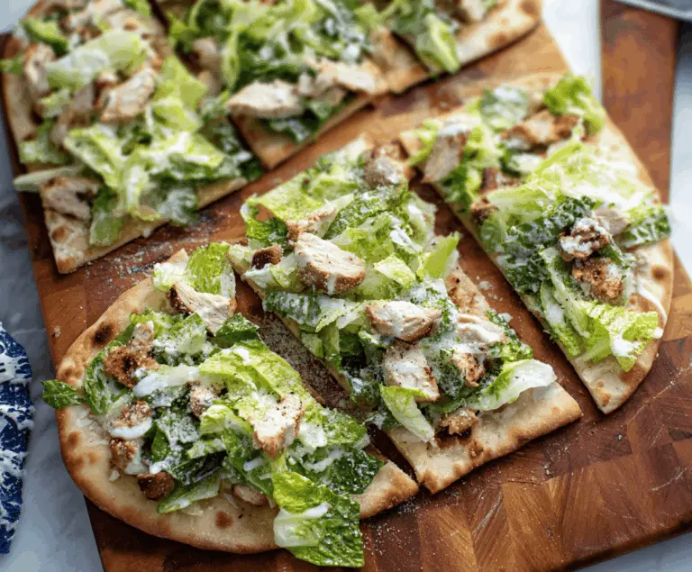 Delicious Chicken Caesar Flatbread topped with crisp lettuce and creamy Caesar dressing