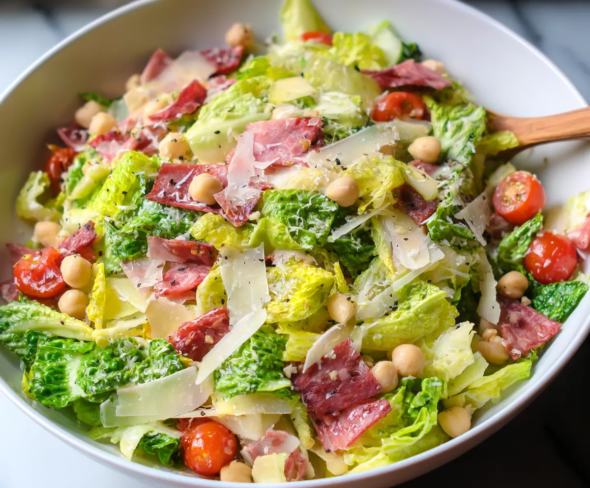 Fresh La Scala Chopped Salad with colorful vegetables and herbs in a glass bowl.