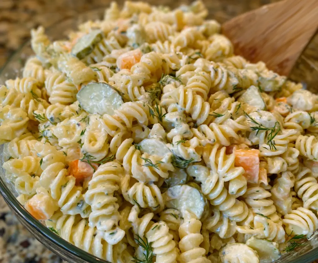 Fresh dill pickle pasta salad with vibrant vegetables and herbs, perfect for summer picnics.