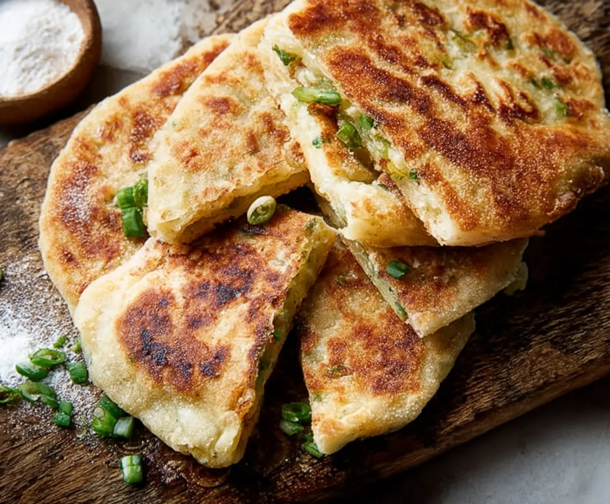 Delicious traditional Irish potato farls served on a rustic wooden plate, showcasing their golden-brown crust and soft interior.