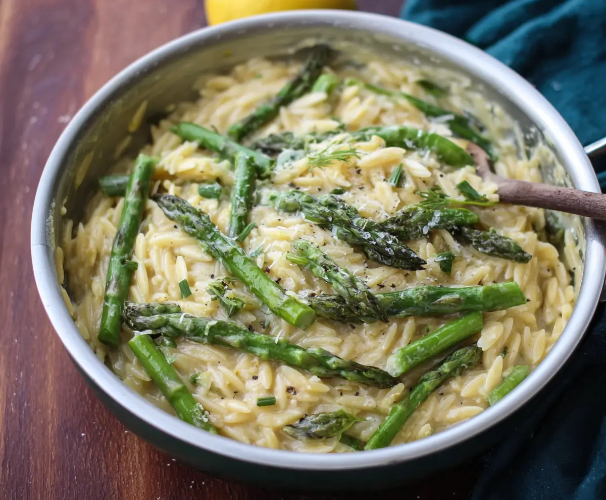Creamy Lemon Garlic Orzo with Asparagus on a plate, showcasing a vibrant and delicious vegetarian dish.