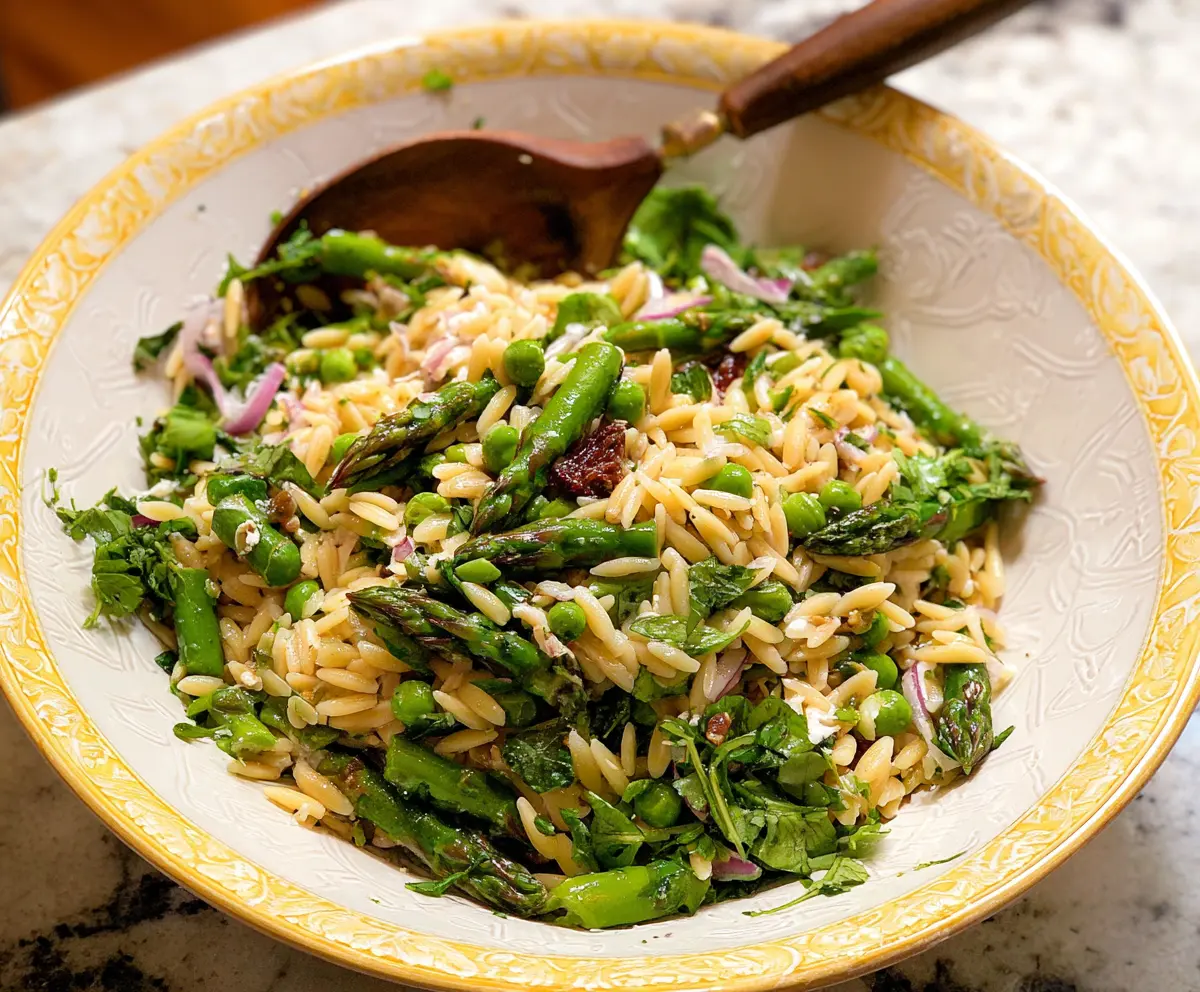 Fresh orzo salad with tender asparagus and colorful vegetables, perfect for a light, healthy meal.